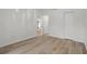 Open bedroom featuring an open entry to another room, vinyl plank flooring, and neutral paint at 3923 Shoreside Cir, Tampa, FL 33624