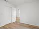 This is a bright bedroom with wood-look floors, closet with white doors, and fresh white paint on the walls at 3923 Shoreside Cir, Tampa, FL 33624