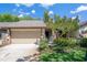 Charming home featuring an attached garage, well-maintained landscaping, and mature trees at 3923 Shoreside Cir, Tampa, FL 33624