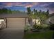 Charming home featuring an attached garage, well-maintained landscaping, and mature trees at 3923 Shoreside Cir, Tampa, FL 33624
