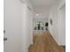 Inviting hallway with wood-look floors, leading to a dining area with natural light at 3923 Shoreside Cir, Tampa, FL 33624