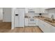 Bright kitchen with white appliances, cabinetry, and granite countertops provides a clean, modern feel at 3923 Shoreside Cir, Tampa, FL 33624