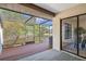 View of a screened in lanai with view of pond, mature landscaping, and glass sliders into an indoor dining area at 3923 Shoreside Cir, Tampa, FL 33624