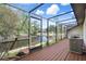 This beautiful screened lanai features a pond view, covered deck, and tropical landscaping providing a relaxing outdoor space at 3923 Shoreside Cir, Tampa, FL 33624