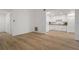 Spacious living area with wood flooring and white walls leads into the bright kitchen at 3923 Shoreside Cir, Tampa, FL 33624