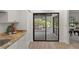 View of outdoor patio from inside, showing sliding glass doors, counter space, and flooring at 3923 Shoreside Cir, Tampa, FL 33624