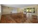 Spacious living room featuring parquet floors, neutral paint, built-in shelving and lots of light at 403 Althea Rd, Belleair, FL 33756