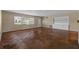 Spacious living room featuring parquet floors, neutral paint, built-in shelving and large windows at 403 Althea Rd, Belleair, FL 33756