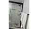 Walk in shower with stone floors, shelves, and marble-style walls at 4103 Gulf Blvd # 104, St Pete Beach, FL 33706