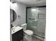 Bathroom featuring modern sink with black fixtures and a shower with stone floors at 4103 Gulf Blvd # 104, St Pete Beach, FL 33706