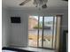 Bedroom featuring a sliding glass door and outdoor seating with views at 4103 Gulf Blvd # 104, St Pete Beach, FL 33706