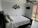 The bedroom features sliding glass doors and modern decor, enhancing natural light and style at 4103 Gulf Blvd # 104, St Pete Beach, FL 33706