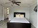 The bedroom features a ceiling fan and modern decor, enhancing the functionality and style at 4103 Gulf Blvd # 104, St Pete Beach, FL 33706