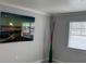 Bright room with a nice painting, a vase, and a window with blinds at 4103 Gulf Blvd # 104, St Pete Beach, FL 33706