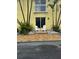 Building exterior with two white chairs on the patio at 4103 Gulf Blvd # 104, St Pete Beach, FL 33706