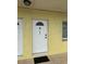 The exterior showcases a well-lit entrance with a secure white door and visible unit number at 4103 Gulf Blvd # 104, St Pete Beach, FL 33706