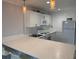Bright kitchen with stone countertops, white cabinets and modern appliances, offering a clean aesthetic at 4103 Gulf Blvd # 104, St Pete Beach, FL 33706