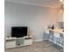 Cozy living room featuring modern flooring and a stylish entertainment center against a soothing neutral wall at 4103 Gulf Blvd # 104, St Pete Beach, FL 33706