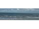 Inviting ocean view with clear water and swimmers enjoying a refreshing experience at 4103 Gulf Blvd # 104, St Pete Beach, FL 33706