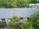 Birds eye view of condo complex highlighting a private balcony, complemented by mature trees at 4215 E Bay Dr # 1005D, Clearwater, FL 33764