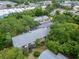 High angle of building overlooking parking lot and mature trees at 4215 E Bay Dr # 1005D, Clearwater, FL 33764