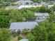 Birds-eye view of building overlooking parking lot and mature trees near retail spaces at 4215 E Bay Dr # 1005D, Clearwater, FL 33764