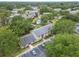 Aerial view of a condo nestled among mature trees and a community pool nearby at 4215 E Bay Dr # 1005D, Clearwater, FL 33764