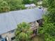 Birds eye view of condo complex featuring a private balcony with outdoor seating and mature trees at 4215 E Bay Dr # 1005D, Clearwater, FL 33764