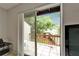 View of the open balcony with tile floor and wood railing overlooking a tranquil garden at 4215 E Bay Dr # 1005D, Clearwater, FL 33764