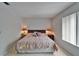 Bedroom features a queen-size bed, tile floors, and ample natural light at 4215 E Bay Dr # 1005D, Clearwater, FL 33764