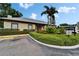 Exterior of the clubhouse featuring lush landscaping and ample parking at 4215 E Bay Dr # 1005D, Clearwater, FL 33764