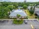 Aerial view of clubhouse, pool, and parking lot with nicely landscaped grounds at 4215 E Bay Dr # 1005D, Clearwater, FL 33764