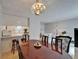 Open-concept dining room featuring a wooden table, a chandelier, and seamless access to the living room and kitchen at 4215 E Bay Dr # 1005D, Clearwater, FL 33764