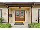 Entrance to Woodside Village Clubhouse with a well maintained walkway and manicured bushes at 4215 E Bay Dr # 1005D, Clearwater, FL 33764