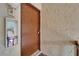 Close-up of a light brown entrance door with textured walls at 4215 E Bay Dr # 1005D, Clearwater, FL 33764