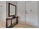 Bright entryway features tiled floor, mirror, and a white front door with security chain at 4215 E Bay Dr # 1005D, Clearwater, FL 33764