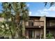 View of the back of the home featuring private balconies and tropical trees at 4215 E Bay Dr # 1005D, Clearwater, FL 33764