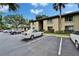 Condominium building exterior with parking lot and well-maintained landscaping at 4215 E Bay Dr # 1005D, Clearwater, FL 33764