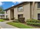 Condominium building exterior featuring a walkway and manicured landscaping at 4215 E Bay Dr # 1005D, Clearwater, FL 33764