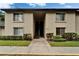 Condominium building exterior featuring a walkway and manicured landscaping at 4215 E Bay Dr # 1005D, Clearwater, FL 33764
