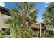 Exterior view of the back of the house with palm trees and a spacious balcony at 4215 E Bay Dr # 1005D, Clearwater, FL 33764