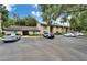 Condominium building exterior with parking lot and well-maintained landscaping at 4215 E Bay Dr # 1005D, Clearwater, FL 33764