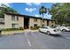 Condominium building exterior with parking lot and well-maintained landscaping at 4215 E Bay Dr # 1005D, Clearwater, FL 33764