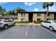 Condominium building exterior with parking lot and well-maintained landscaping at 4215 E Bay Dr # 1005D, Clearwater, FL 33764