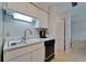 The kitchen showcases sleek white cabinets and modern appliances, complemented by a functional layout and neutral tile flooring at 4215 E Bay Dr # 1005D, Clearwater, FL 33764