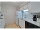 Bright kitchen features white cabinetry, essential appliances, and neutral tiling, offering a functional and clean cooking space at 4215 E Bay Dr # 1005D, Clearwater, FL 33764