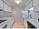 Efficient kitchen featuring white cabinets, modern appliances, and neutral tile flooring for a clean and functional space at 4215 E Bay Dr # 1005D, Clearwater, FL 33764
