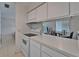 The kitchen has white cabinetry, a pass-through window, and modern appliances, providing a functional and aesthetically pleasing cooking area at 4215 E Bay Dr # 1005D, Clearwater, FL 33764