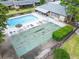Aerial view of community pool with shuffleboard courts, tables, and ample seating at 4215 E Bay Dr # 1005D, Clearwater, FL 33764