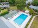 Overhead shot showcases the pool, shuffleboard and common areas surrounded by manicured lawns at 4215 E Bay Dr # 1005D, Clearwater, FL 33764